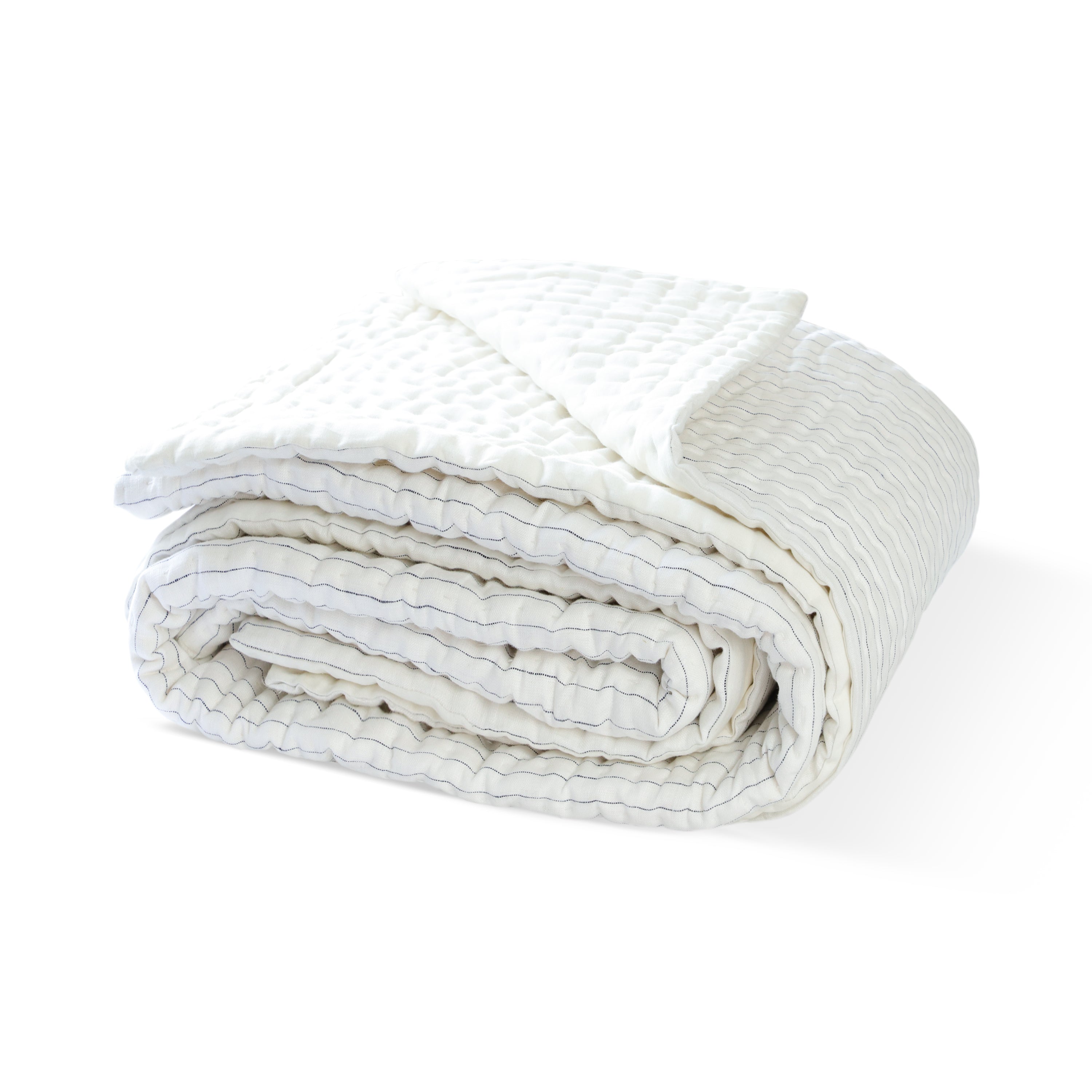 The linen quilt can be used as a coverlet or bedspread. Use it to accent a bed for a textural look and stripes pattern.
