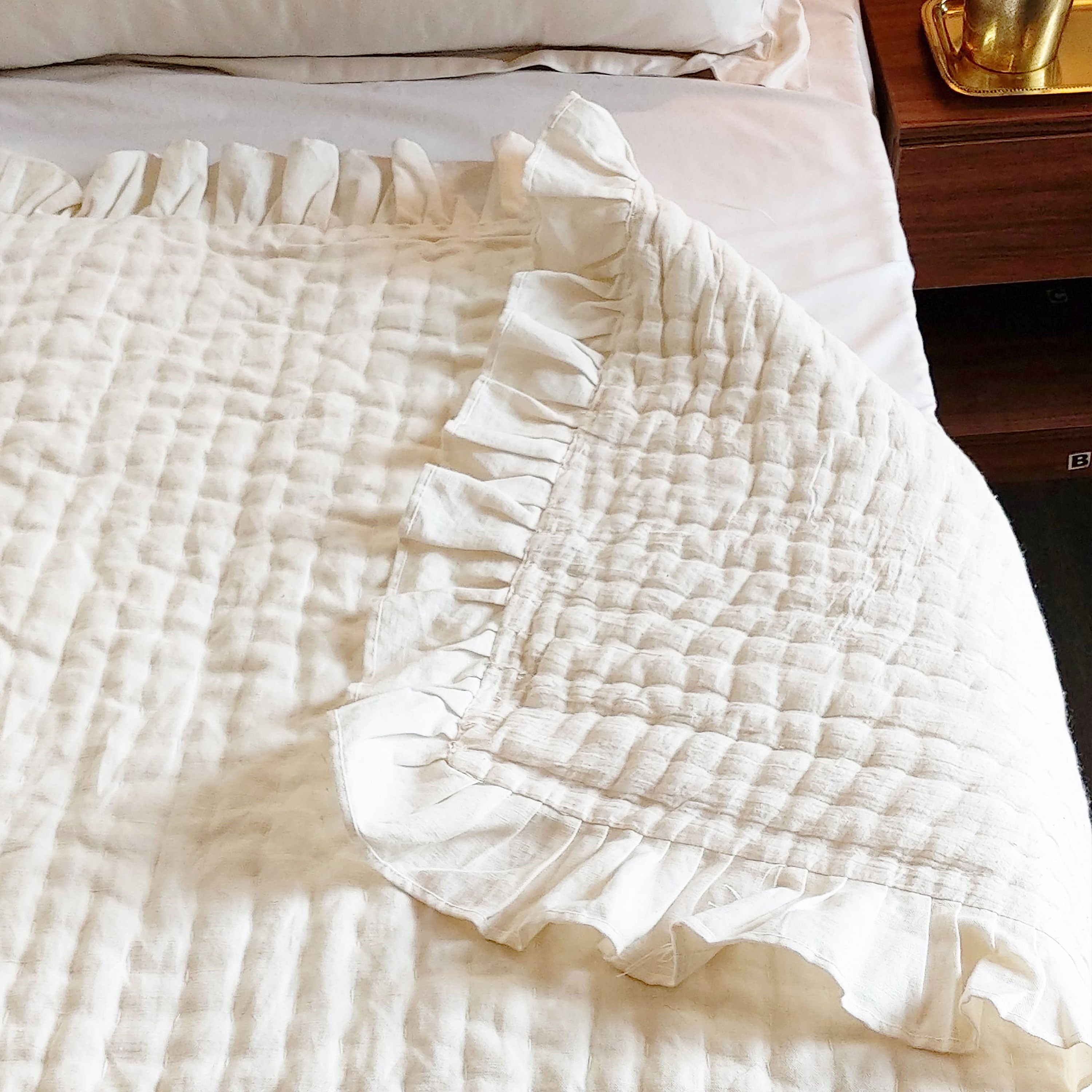 Handcrafted luxe ivory linen quilt with channel stitching, reversible to soft cotton. Pre-washed for natural softness, perfect as a bedspread.