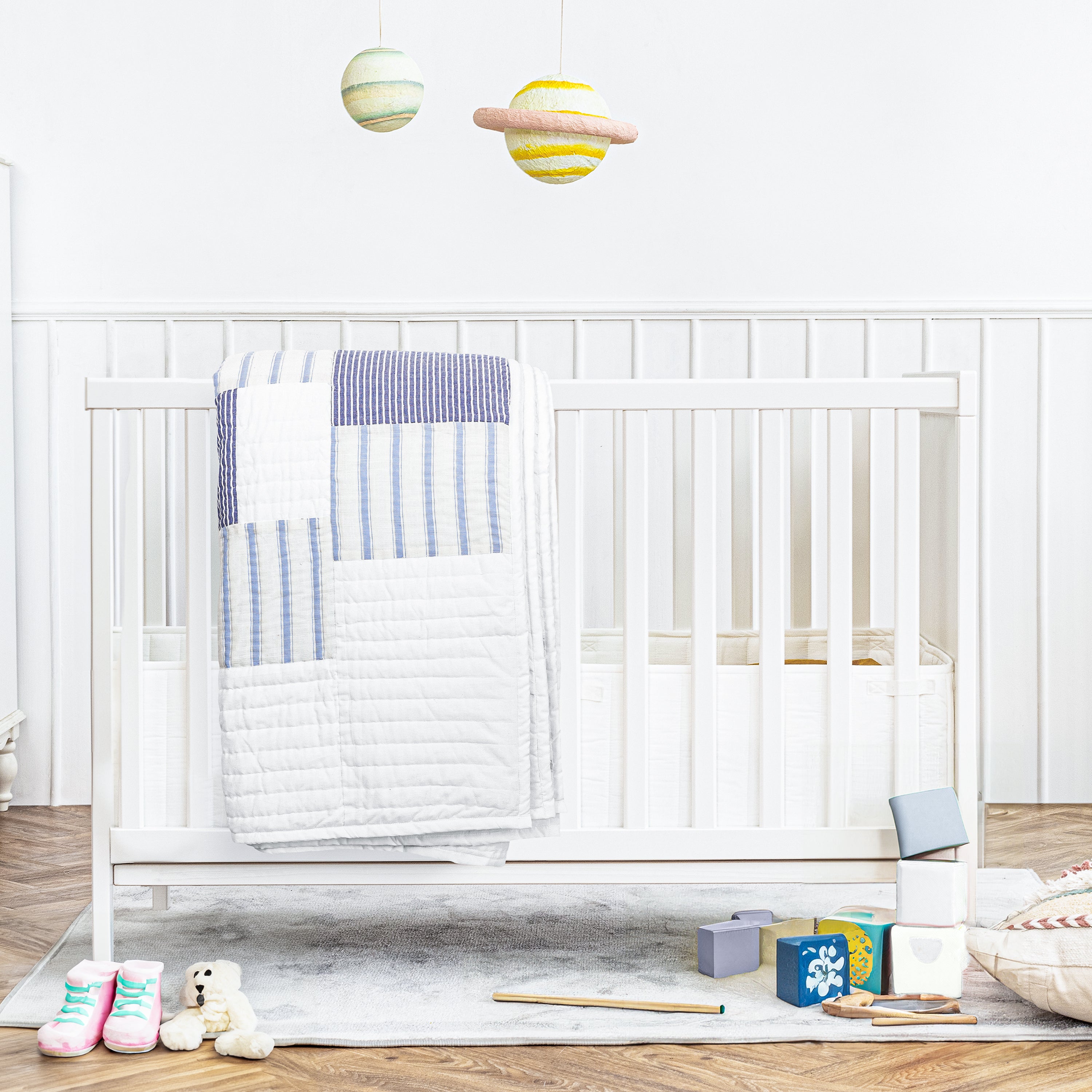 Handcrafted blue and white cotton patchwork striped quilt. Washable comforter for nursery.