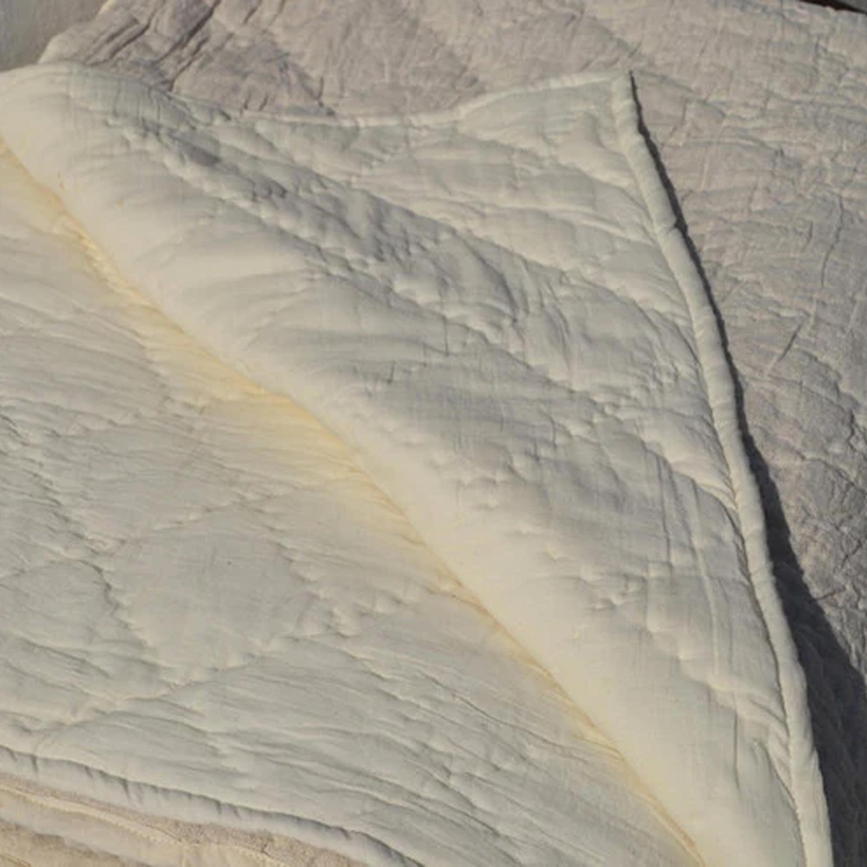 Made with cotton batting and cotton fabric backing, this quilt features cotton stuffing. Spot cleaning recommended for care.