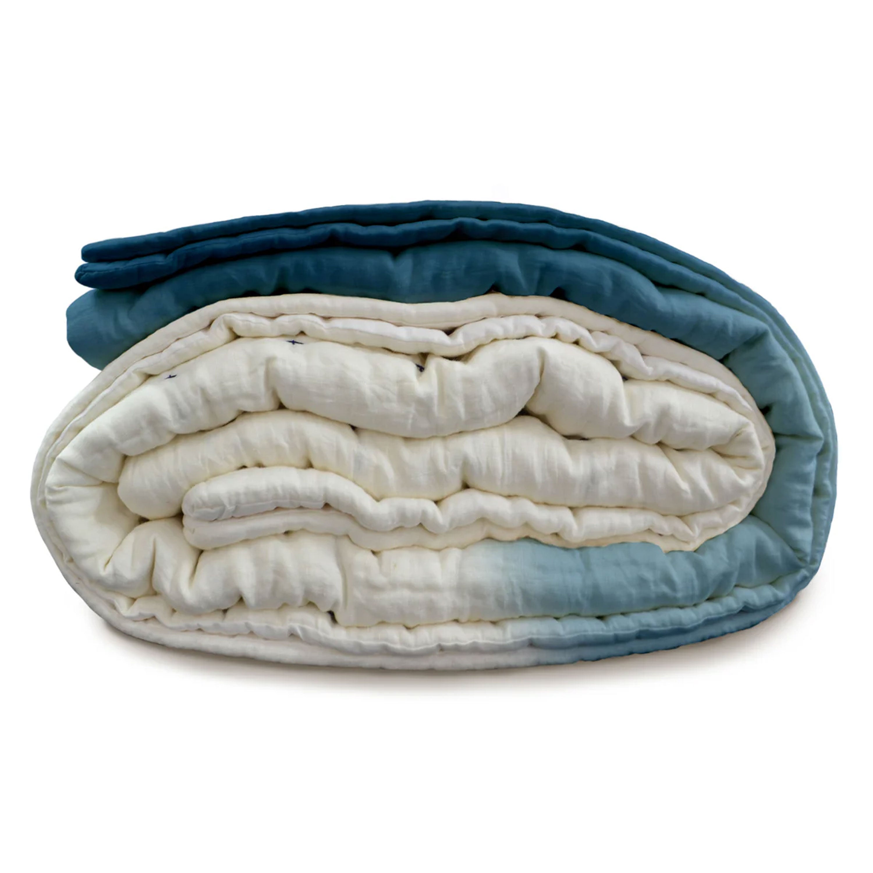 Folded indigo ombre linen quilt highlighting its soft texture and space-saving design. Perfect for twin XL beds and compact dorm living, this breathable, easy-care quilt suits boho and minimalist dorm styles. Machine washable for effortless upkeep. Great for college students on the go quilt.