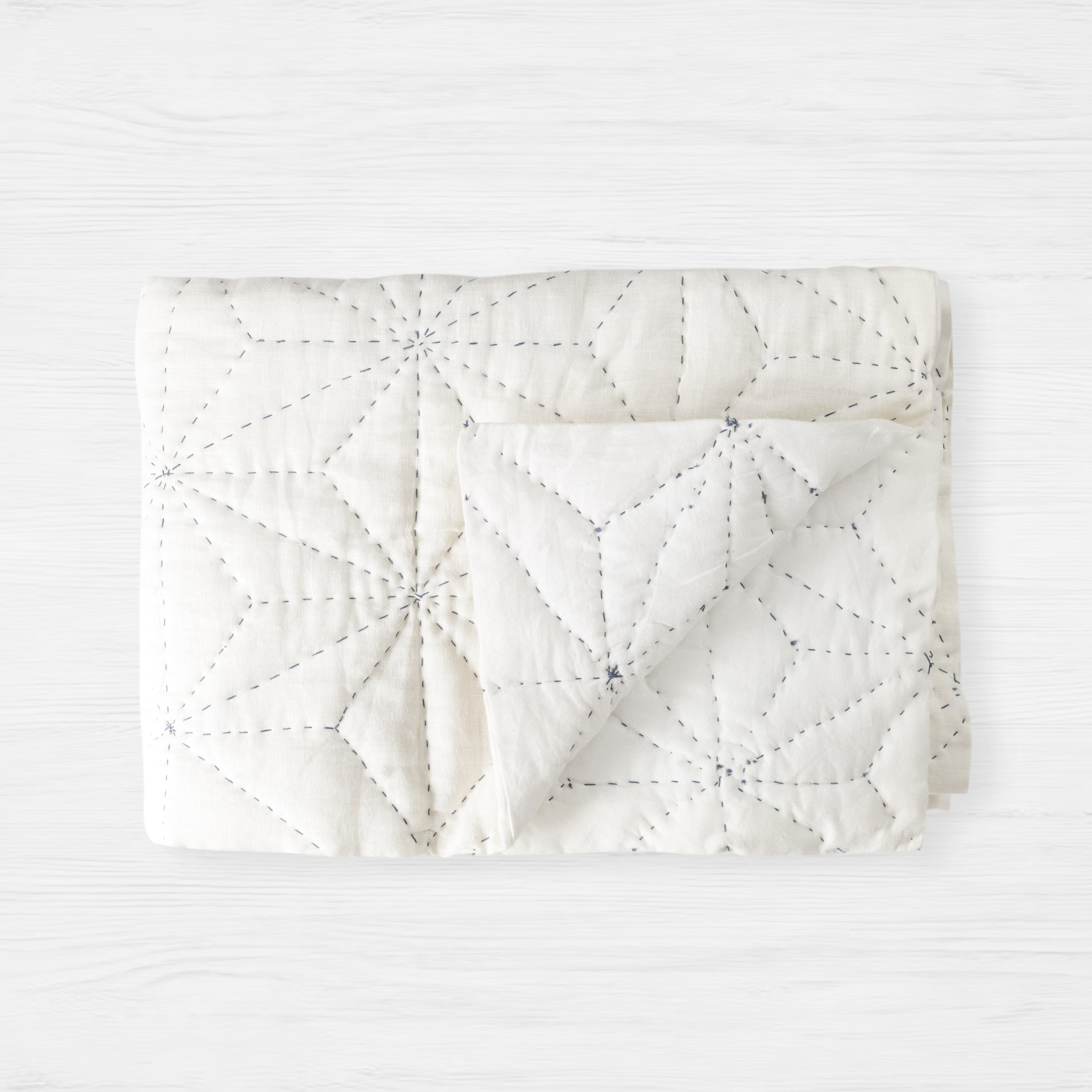 Linen quilt with Japanese Asanoha hemp leaf motif, symbolizing growth and well-being. The coverlet is handcrafted.
