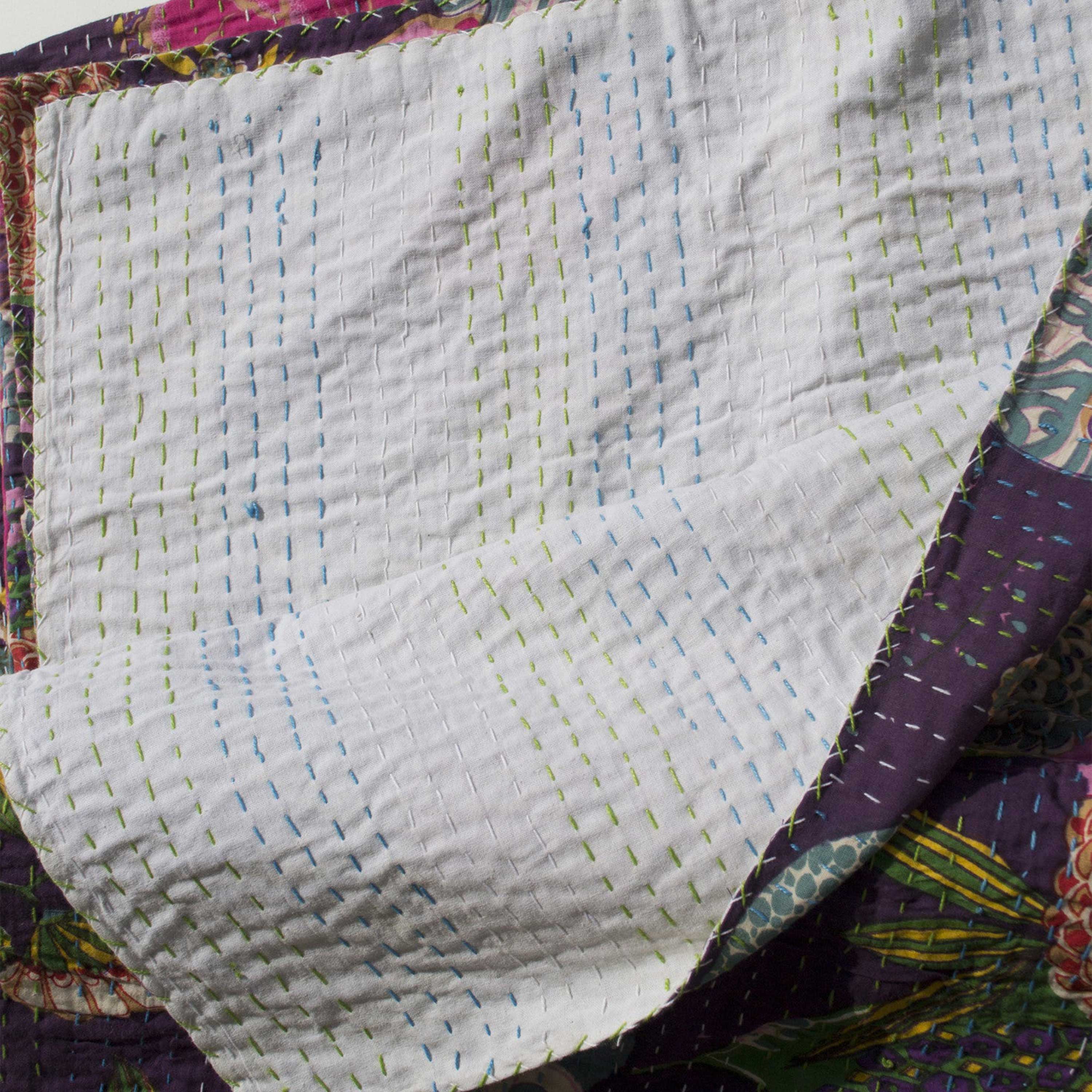 Traditional hand-quilted: Made by sewing cotton layers together with visible running stitches, this quilt features a floral pattern on one side and plain cotton fabric on the reverse.