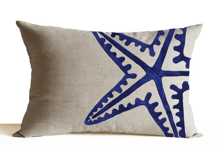 "Embroidered starfish on linen pillow cover - nautical beach decor for coastal, tropical, or dorm room styling."