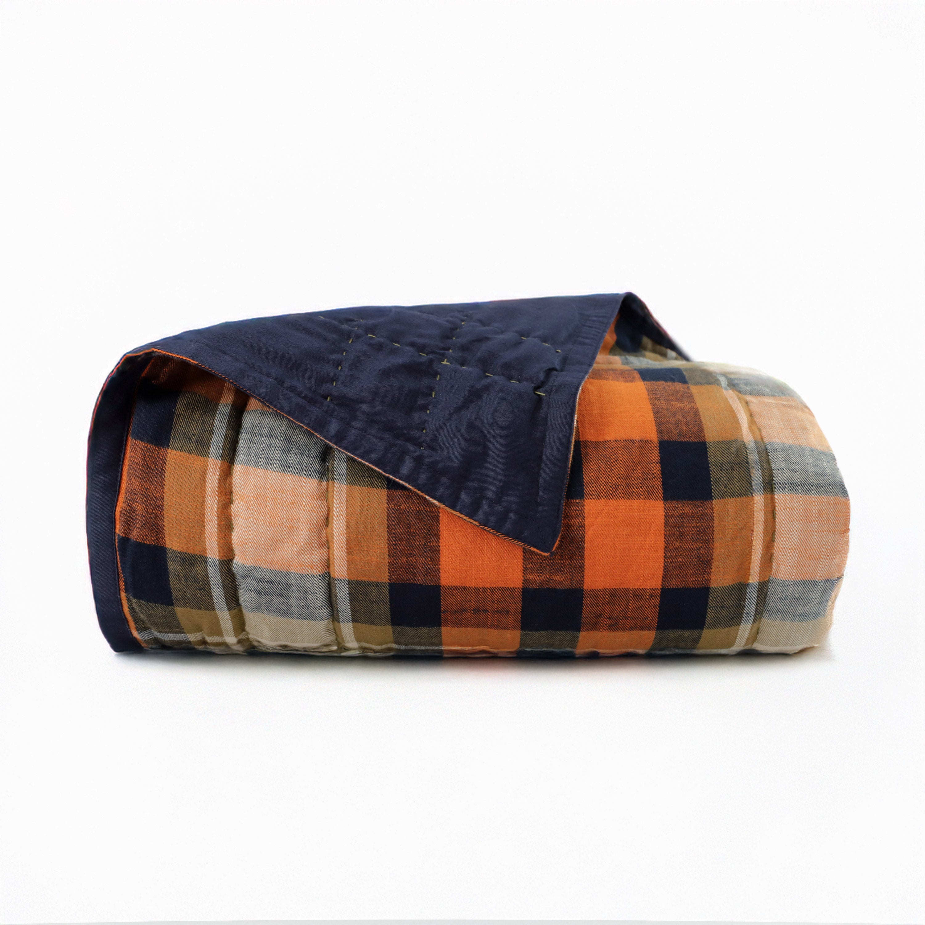 "Reversible cotton quilt with plaid and solid navy sides, 100% cotton, medium-weight for year-round comfort, handcrafted design."