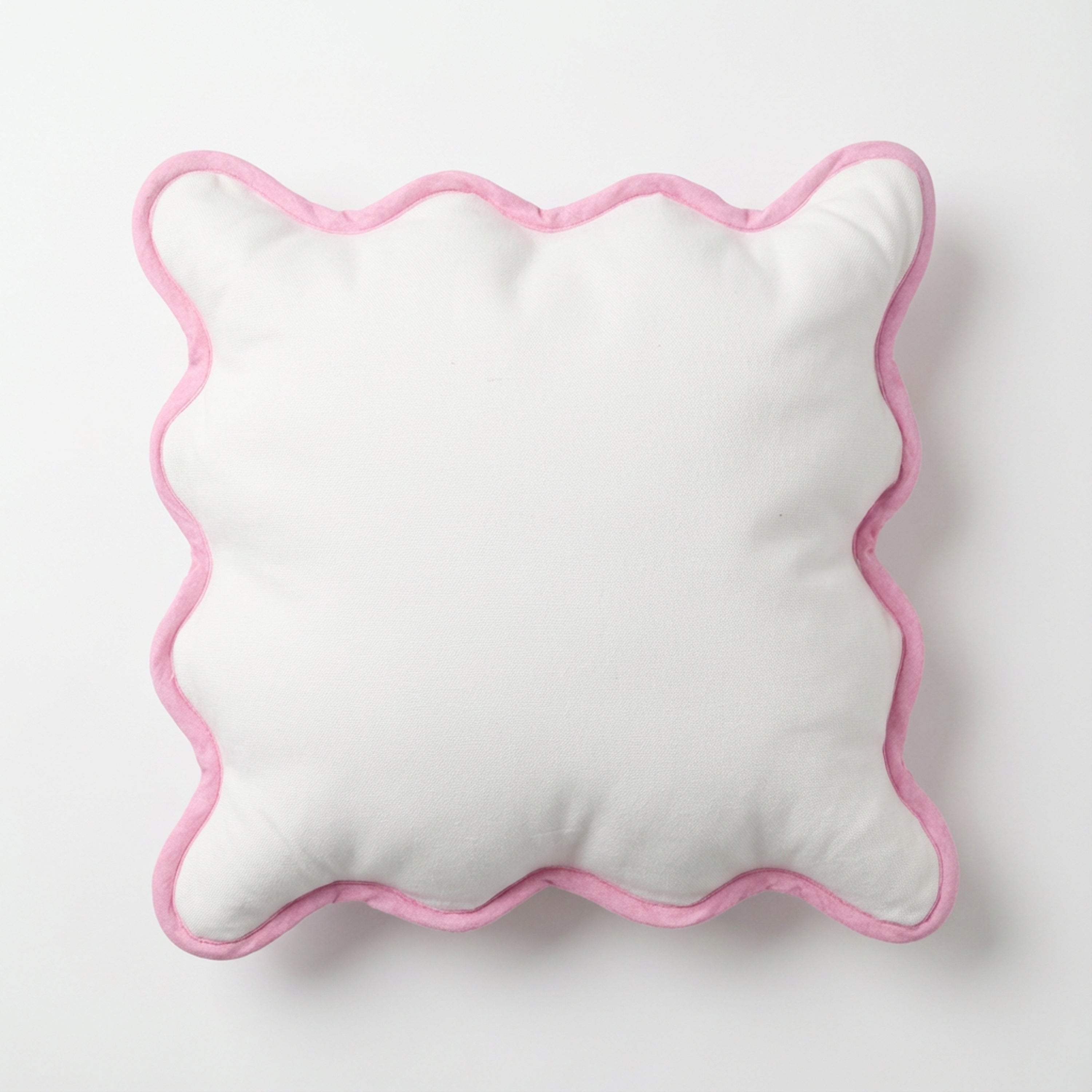 A full top-down view of the square white cotton pillow cover featuring a distinctive pink scalloped edge. The symmetrical wavy border adds a playful yet sophisticated touch to contemporary and vintage-inspired spaces. This versatile pink trim cushion cover is perfect for layering on beds or sofas to create a serene, inviting atmosphere. A must-have for the coquette and soft girl room decor trend, offering a dreamy, artistic texture to any modern home.
