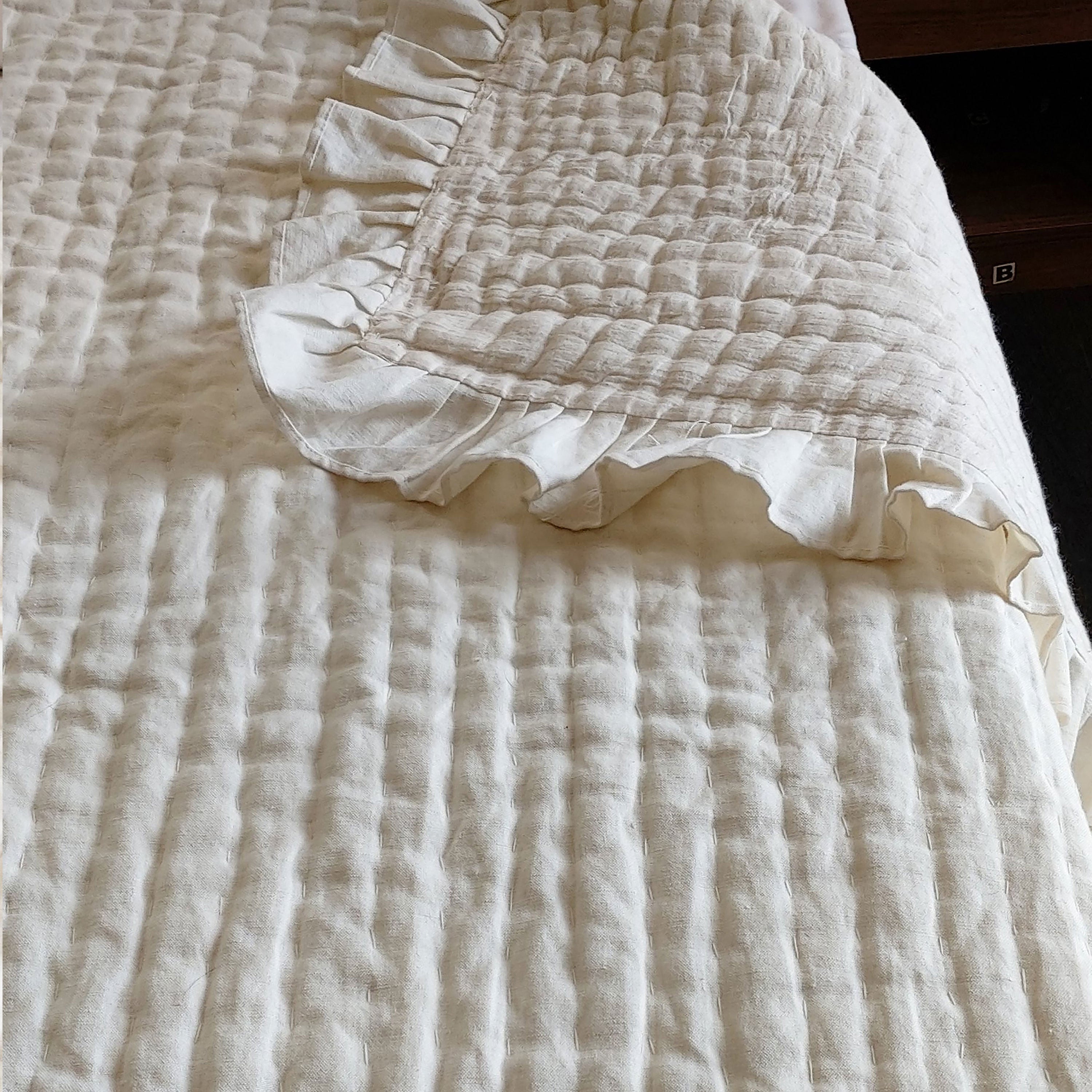 "Handcrafted ivory linen quilt, reversible to cotton. Pre-washed for softness, ideal as a cozy bedspread, coverlet, or throw for year-round comfort."