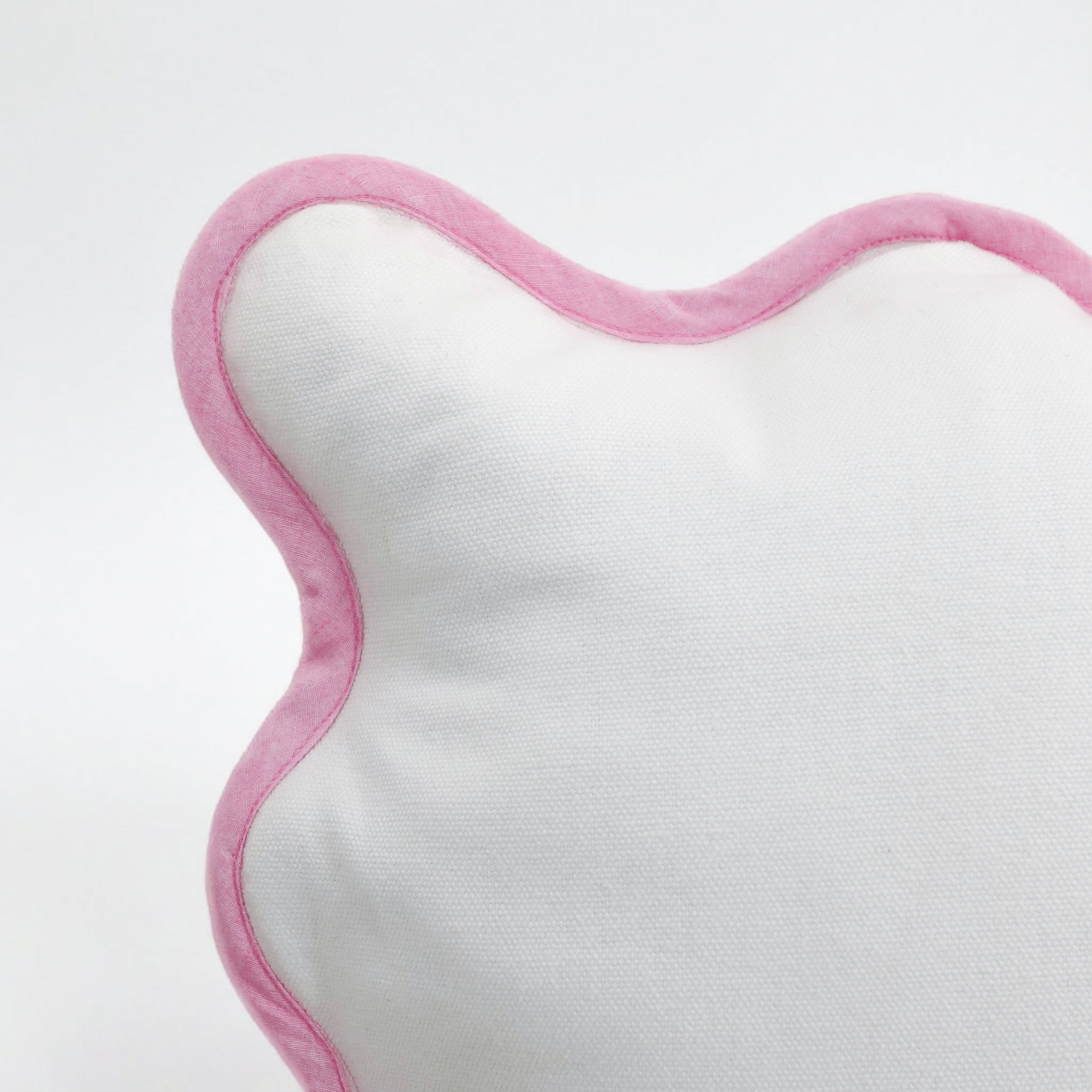 A close-up shot of the elegant pink scalloped edge on a white cotton pillow cover. This detail highlights the precision stitching and high-quality pink trim that defines the feminine, soft girl aesthetic. Perfect for cottagecore or romantic bedroom decor, this breathable cotton cushion cover by Amore Beauté offers a refined, structured look. Ideal for home stylists seeking durable yet dainty decorative accents with a vintage-inspired charm.
