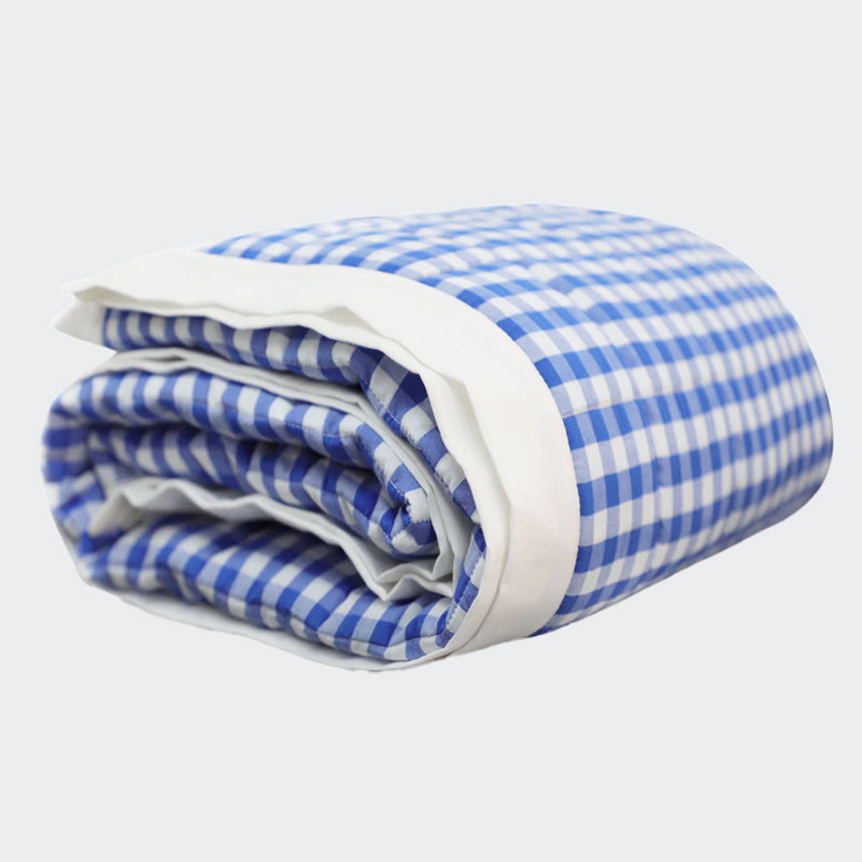 Timeless quilt: Featuring a blue and white gingham pattern on the front and a seamless white cotton reverse, this quilt is filled with soft polyfill batting. Wash in gentle mode with mild detergent. 