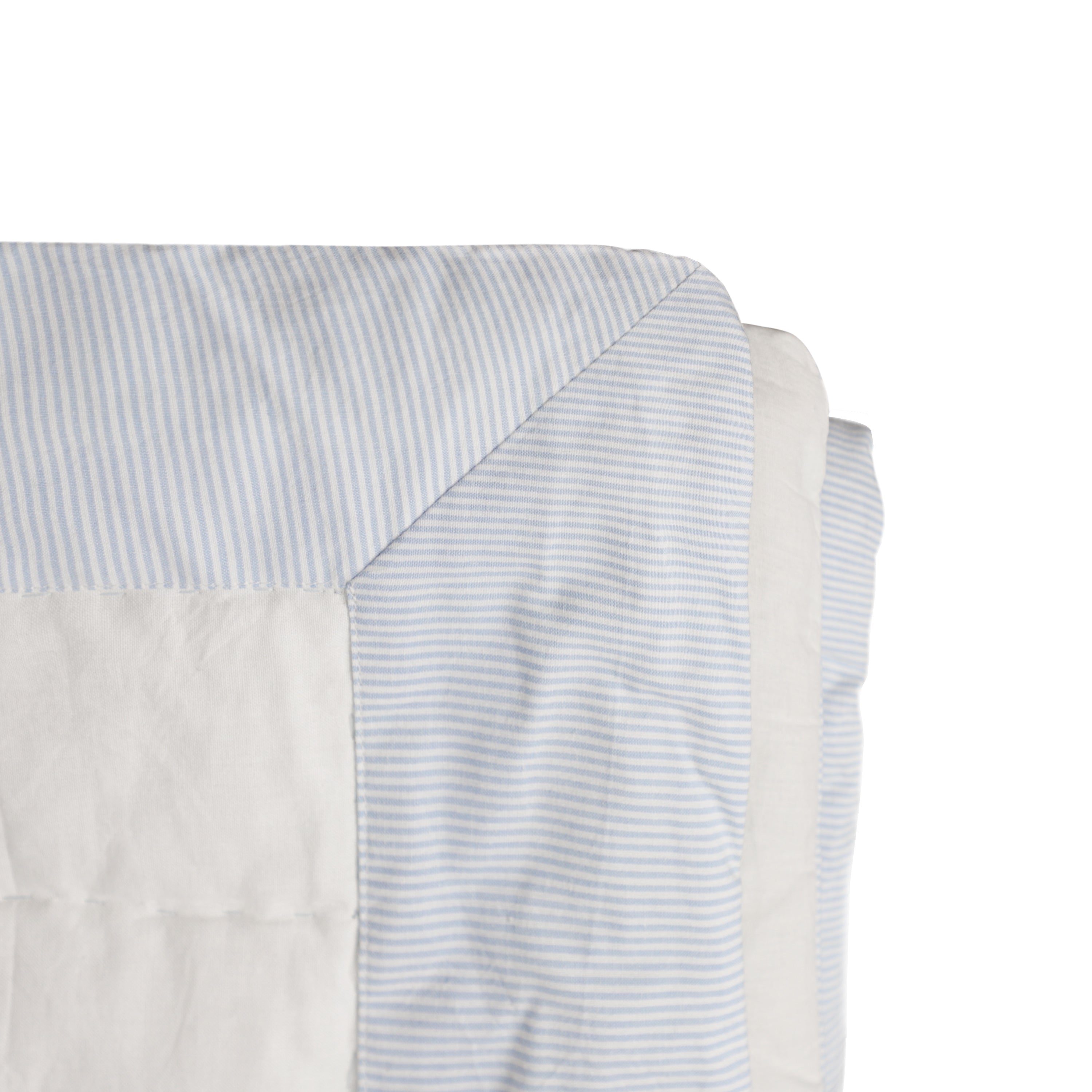 "Made to order, this quilt is crafted with cotton fabric on both sides, featuring a blue-and-white striped edge and solid cotton reverse. It’s filled with soft cotton batting and machine washable on a gentle cycle."