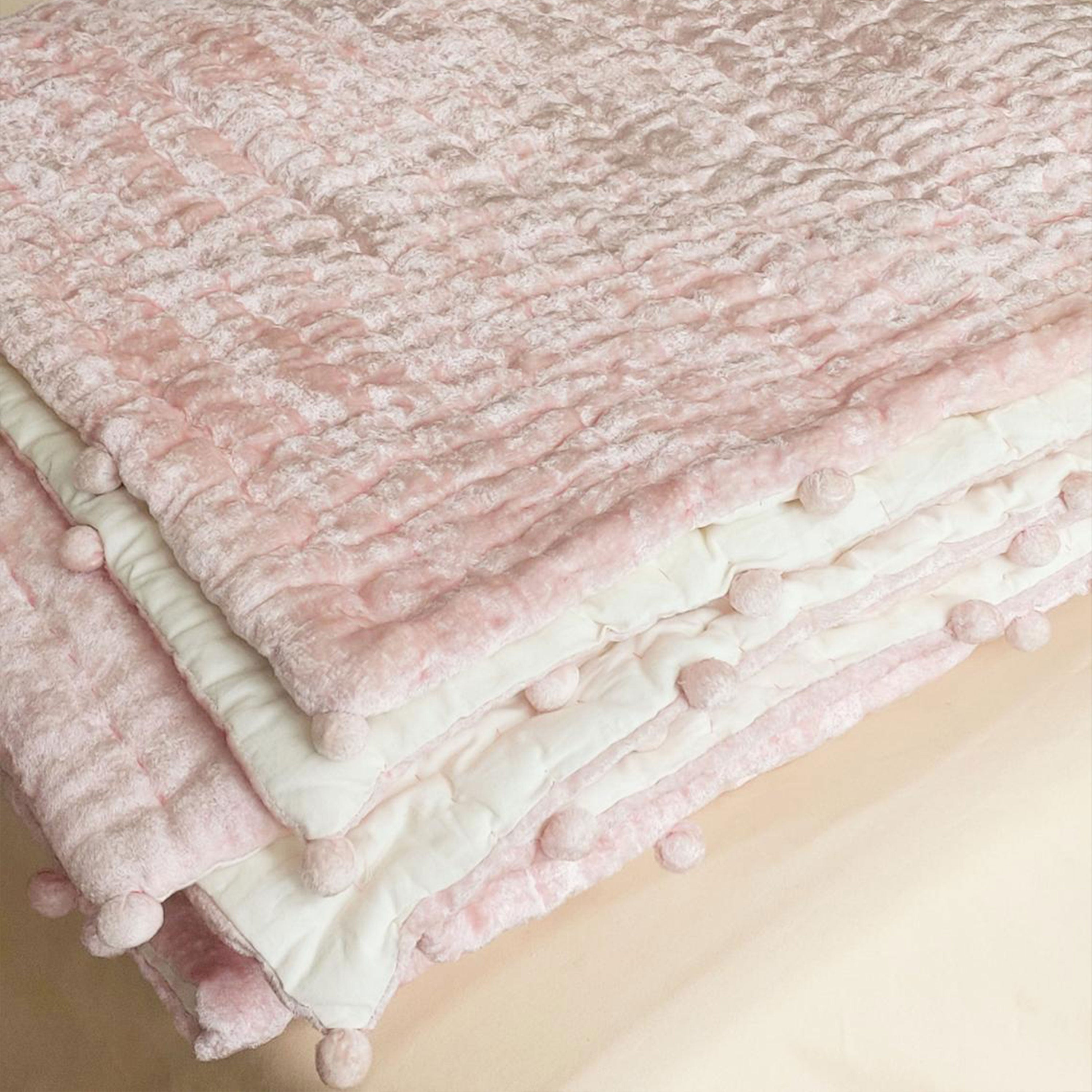 Made to order with velvet on top, reversing to cotton voile, and filled with cotton batting, this quilt is machine washable on a gentle cycle.