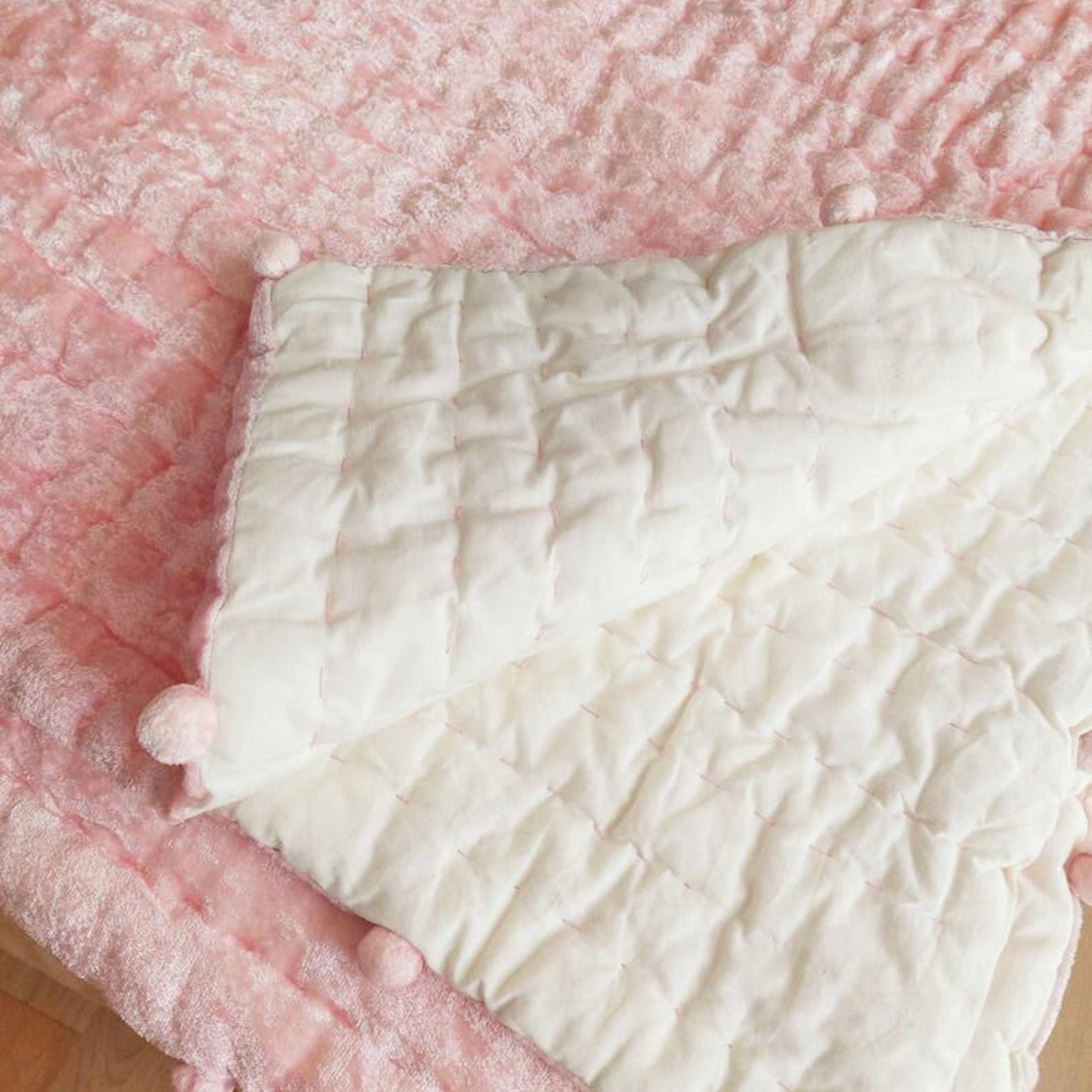 This timeless quilt is precisely hand quilted for a unique texture and tonal look, with a pre-washed finish for softness. Made from cozy velvet, it functions as a bedspread, coverlet, or blanket, perfect for year-round use.