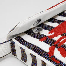Snap button closure detail on the open flap of the Handmade Beaded Crab Clutch.