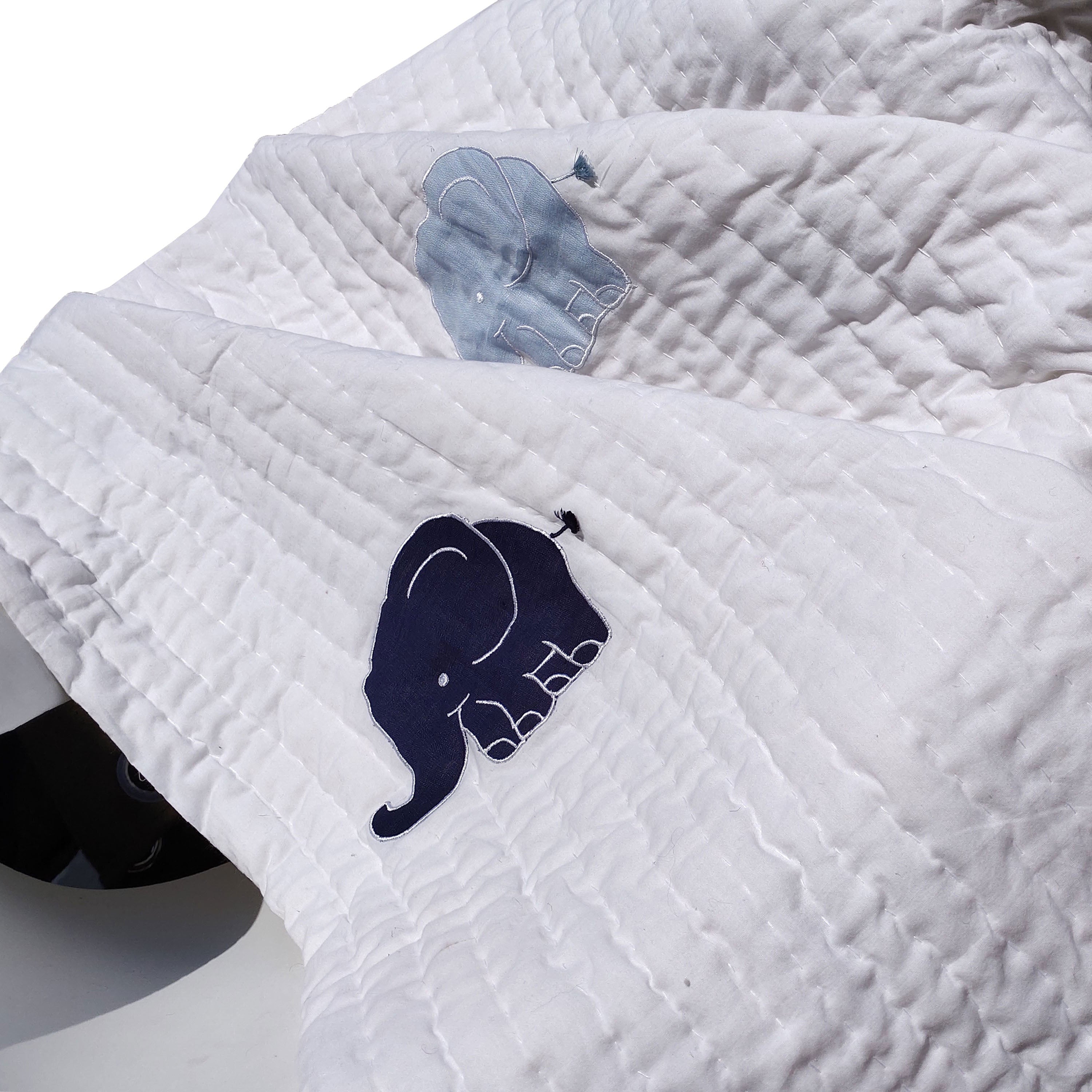 Pick-stitched quilt features cotton on top and cotton voile on the reverse, with soft cotton batting. Machine washable on a gentle cycle, but not tumble dry.