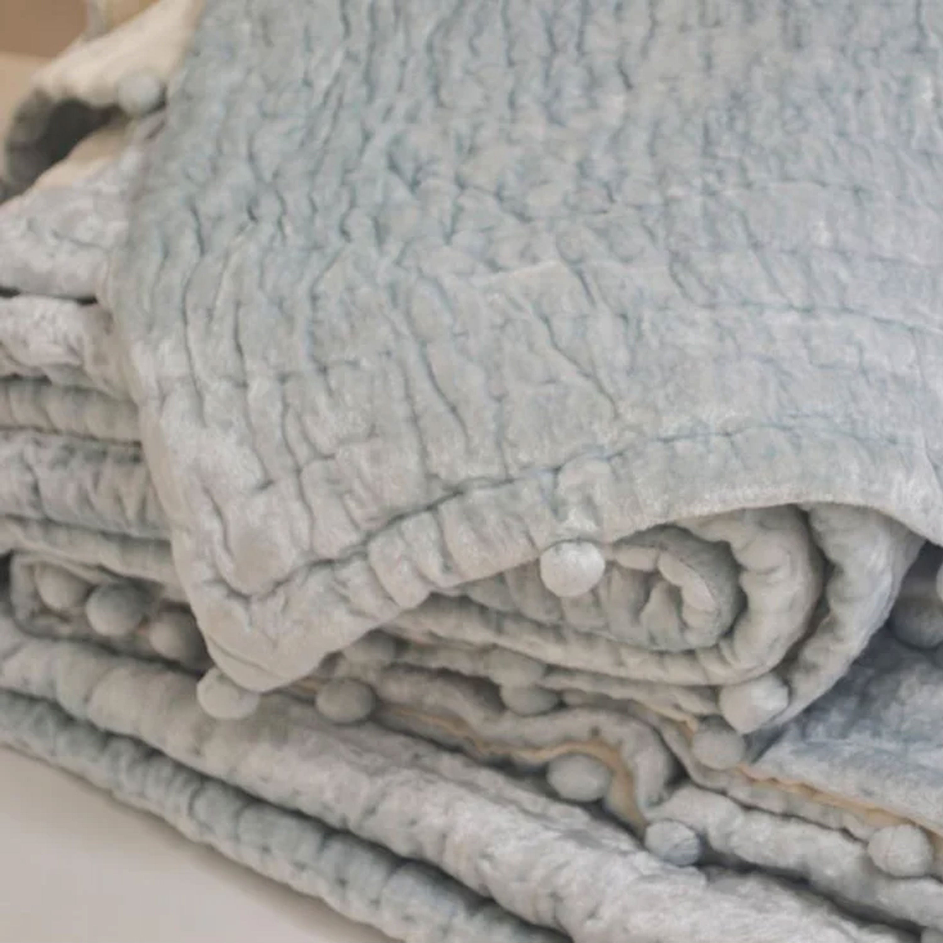 Handcrafted with velvet on top, reversing to cotton voile and filled with cotton batting, this quilt is machine washable on a gentle cycle for easy care.