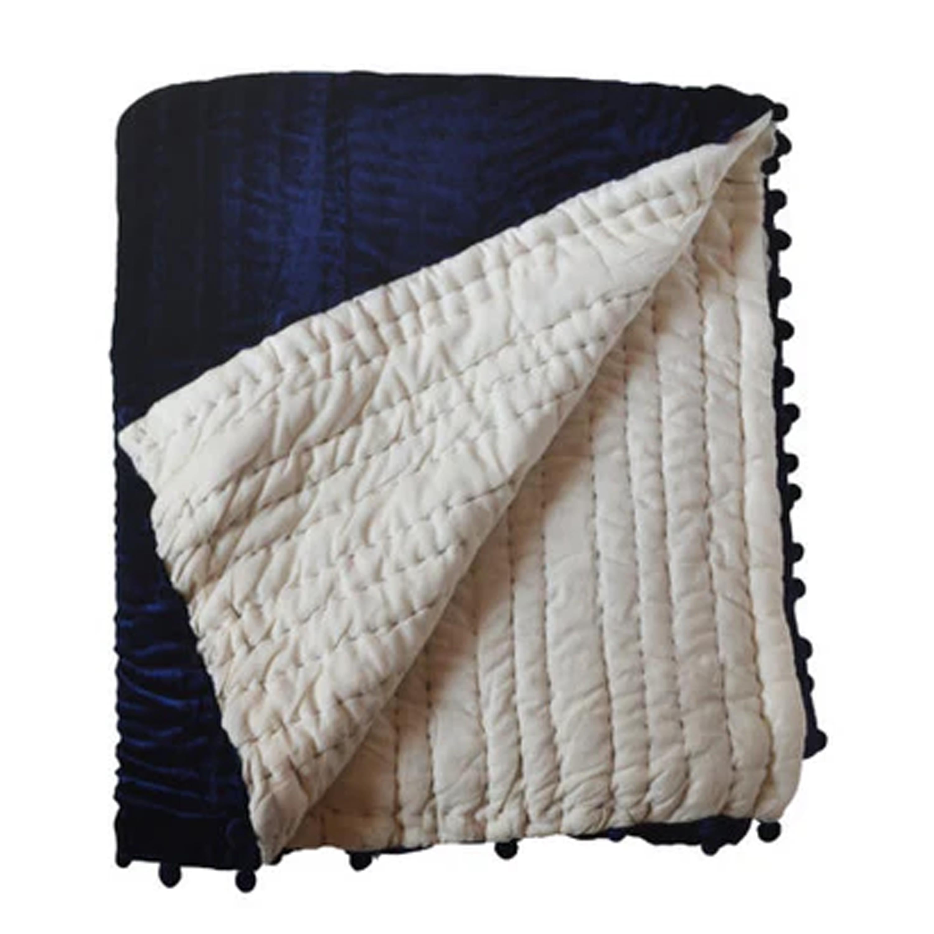 This plush velvet quilt features a pick-stitched design, reversing to equally soft cotton fabric for added comfort. The precise hand quilting creates a unique texture and tonal elegance in every piece.