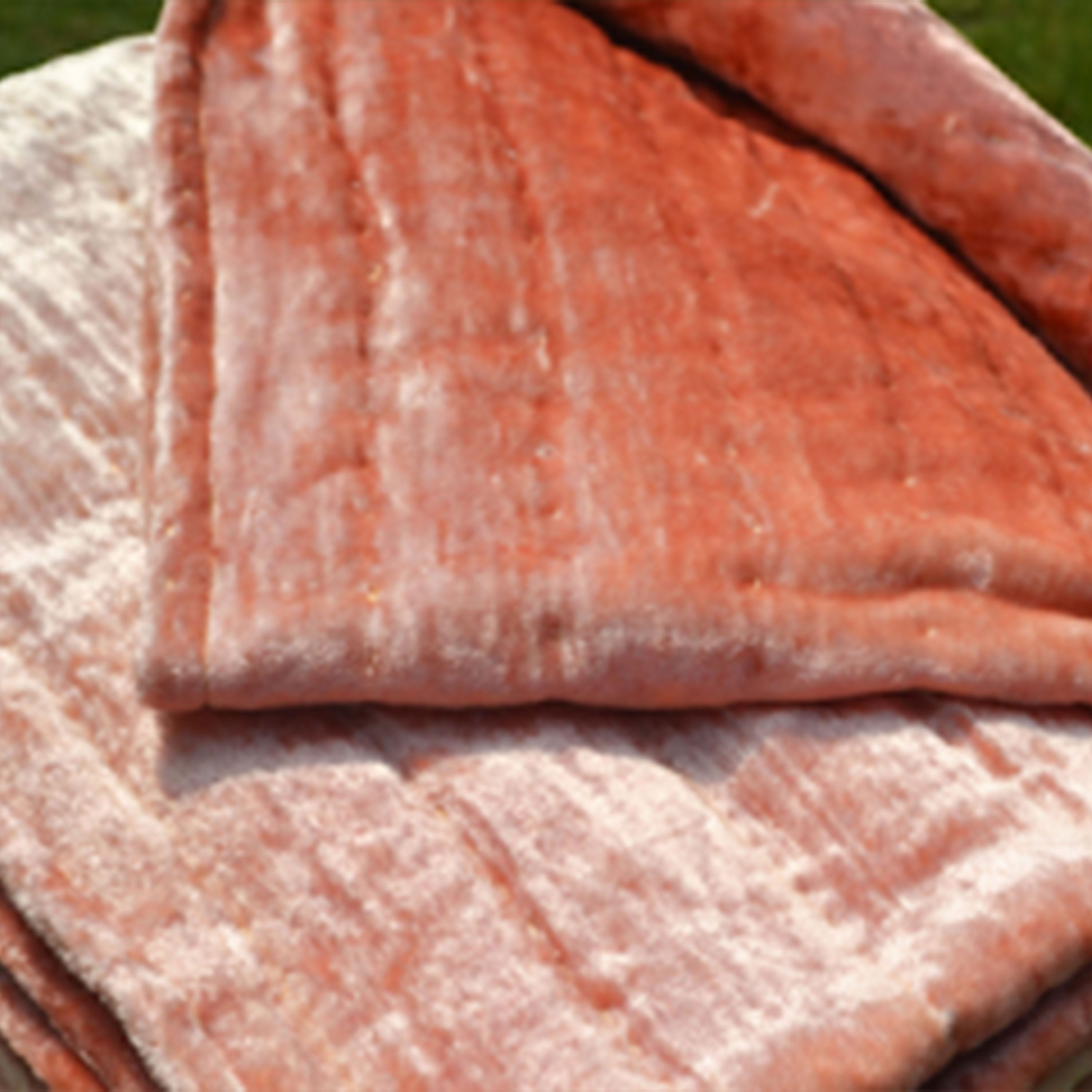 This timeless quilt, crafted from plush peach velvet, reverses to soft cotton fabric. Precisely hand-quilted, it features a unique texture and elegant tonal look.