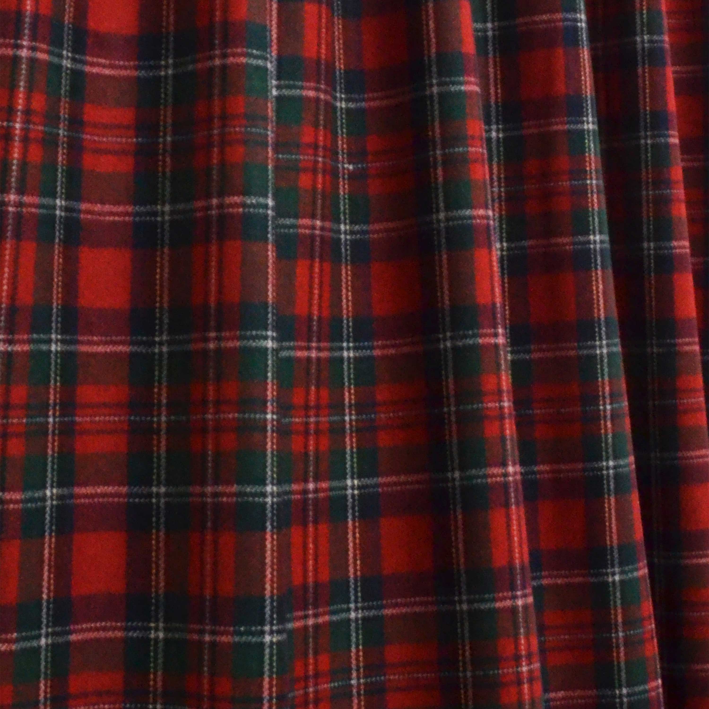 "Crafted from high-quality wool, these curtains are both durable and stylish." The red, white, and green plaid pattern adds a touch of traditional charm to any room, while the wool fabric offers insulation and draft-blocking properties to keep your home warm and energy-efficient.