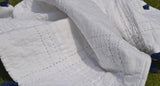 Amore Beaute soft custom quilt has squares embroidered in pick stitch pattern.