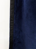Amore Beaute navy blue velvet curtain with black trim.