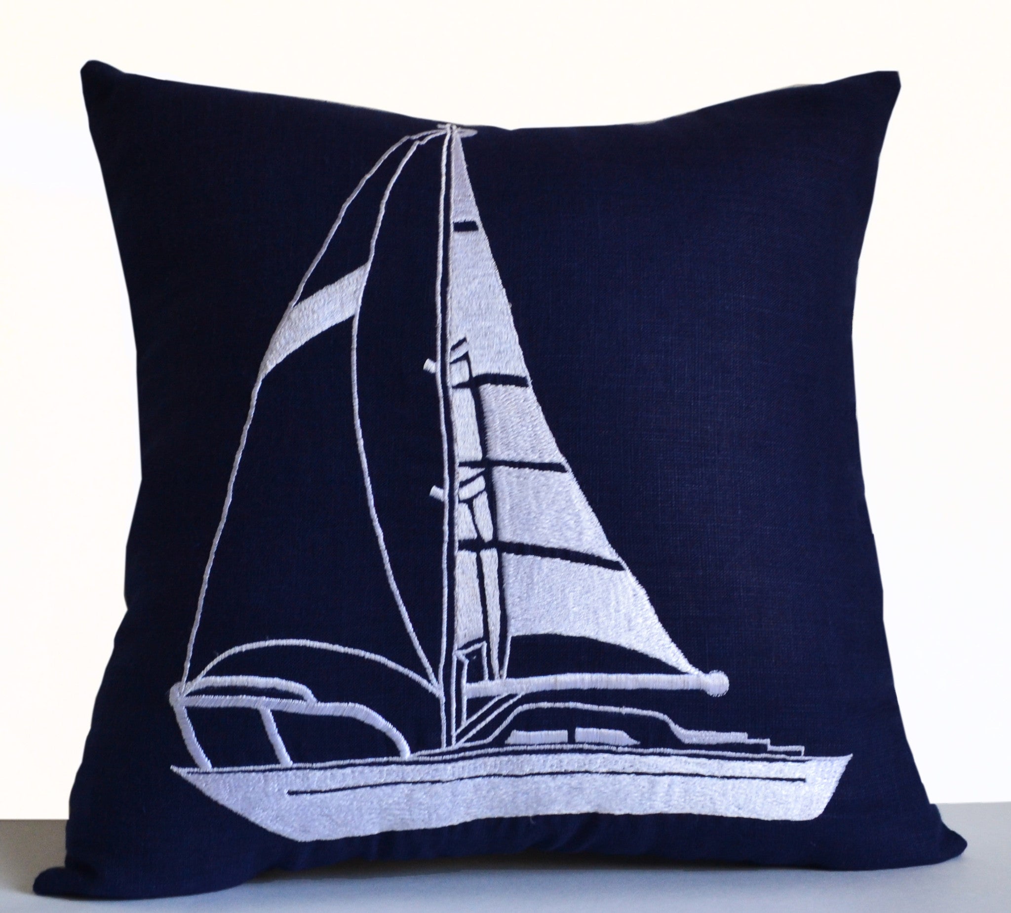 Handmade navy blue linen throw pillow with yacht motif