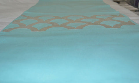 Teal colored embroidered table runner