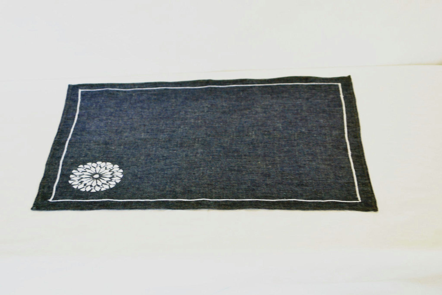 Embroidered place mats in navy blue and white