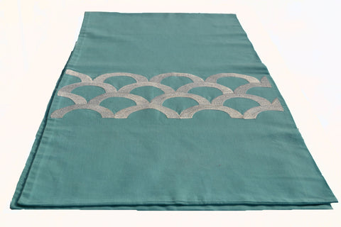 Teal colored embroidered table runner