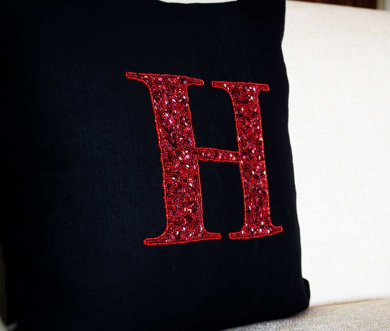 Handmade decorative red pillow cover with monogram and sequin