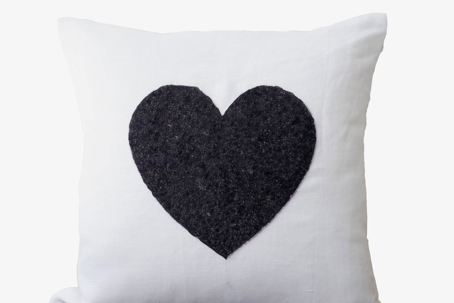 Handmade white linen throw pillow with black heart sequin