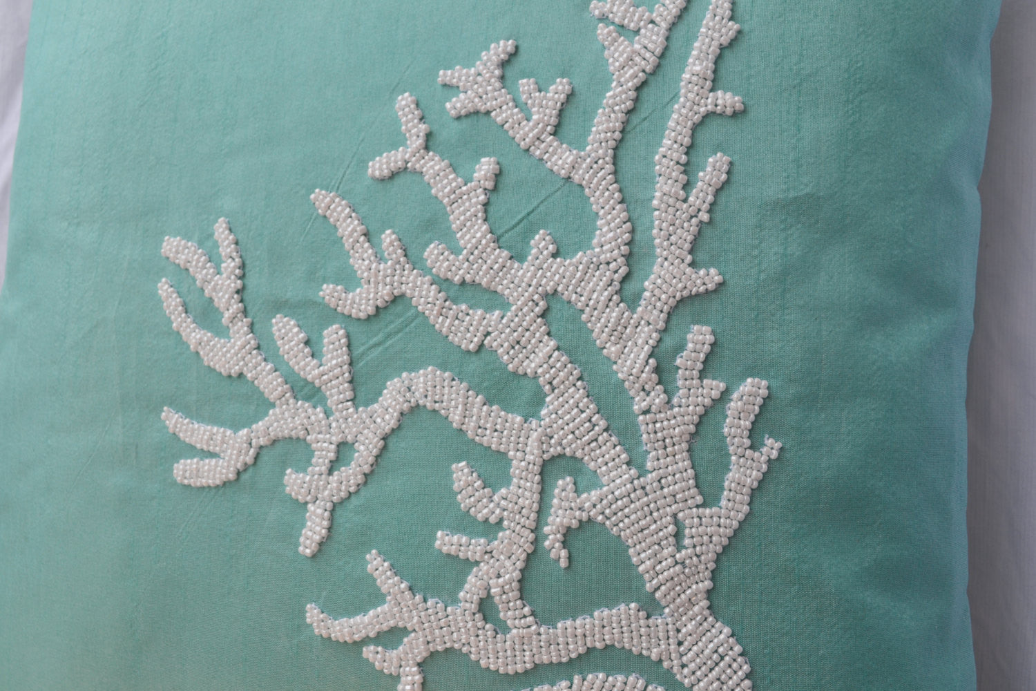 Handmade teal pillow with white coral in beads