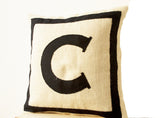 Handmade black cotton cushion with monogram