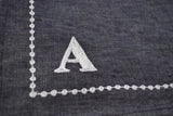 Monogrammed place mats with pearl string embroidery.