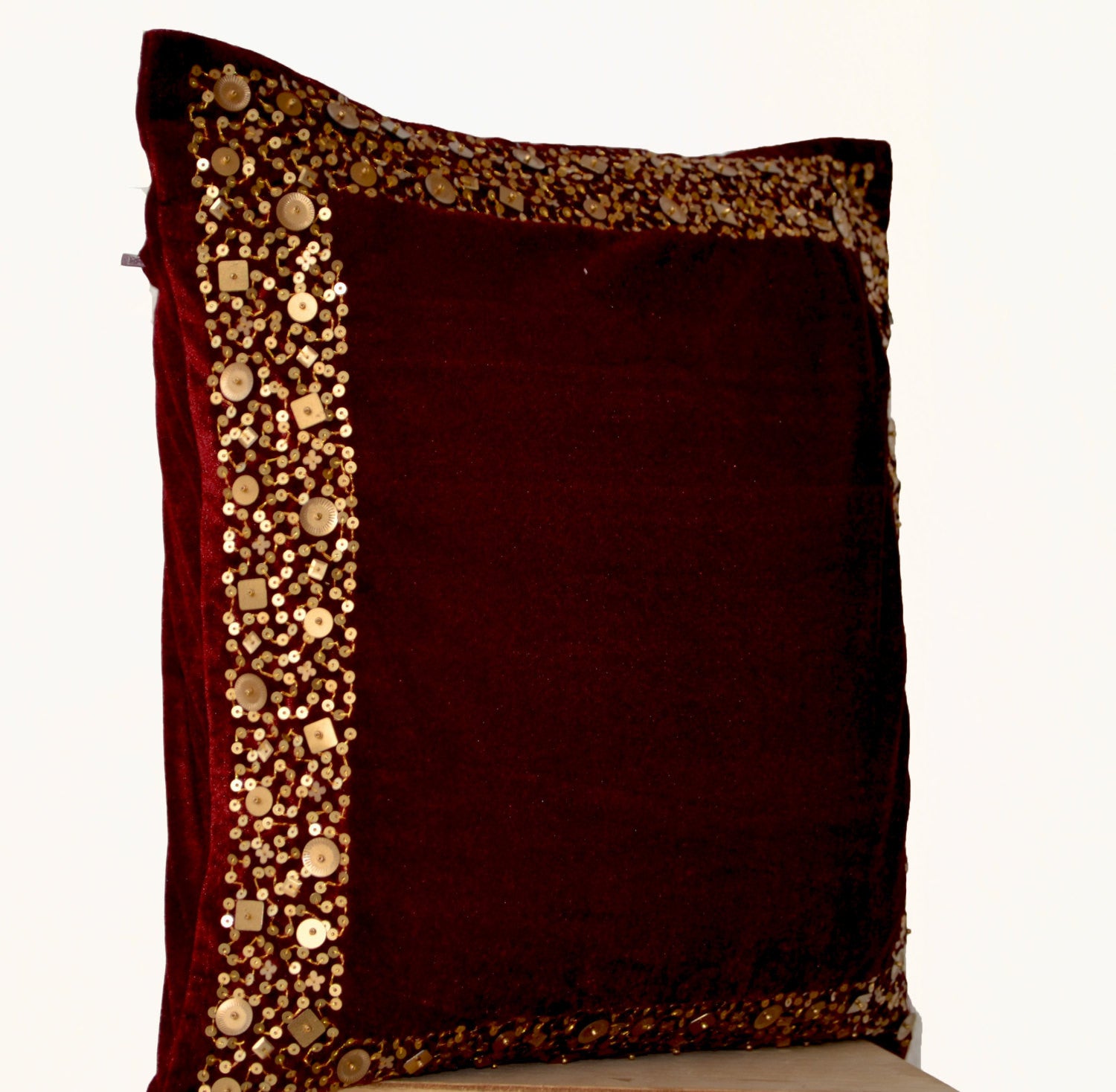 Handmade maroon velvet throw pillows with gold sequin border and beads