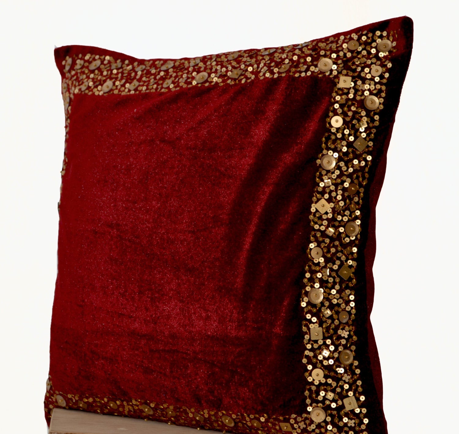 Handmade maroon velvet throw pillows with gold sequin border and beads