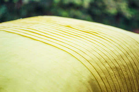 Handmade yellow art silk cushion with rippled pin tuck pattern