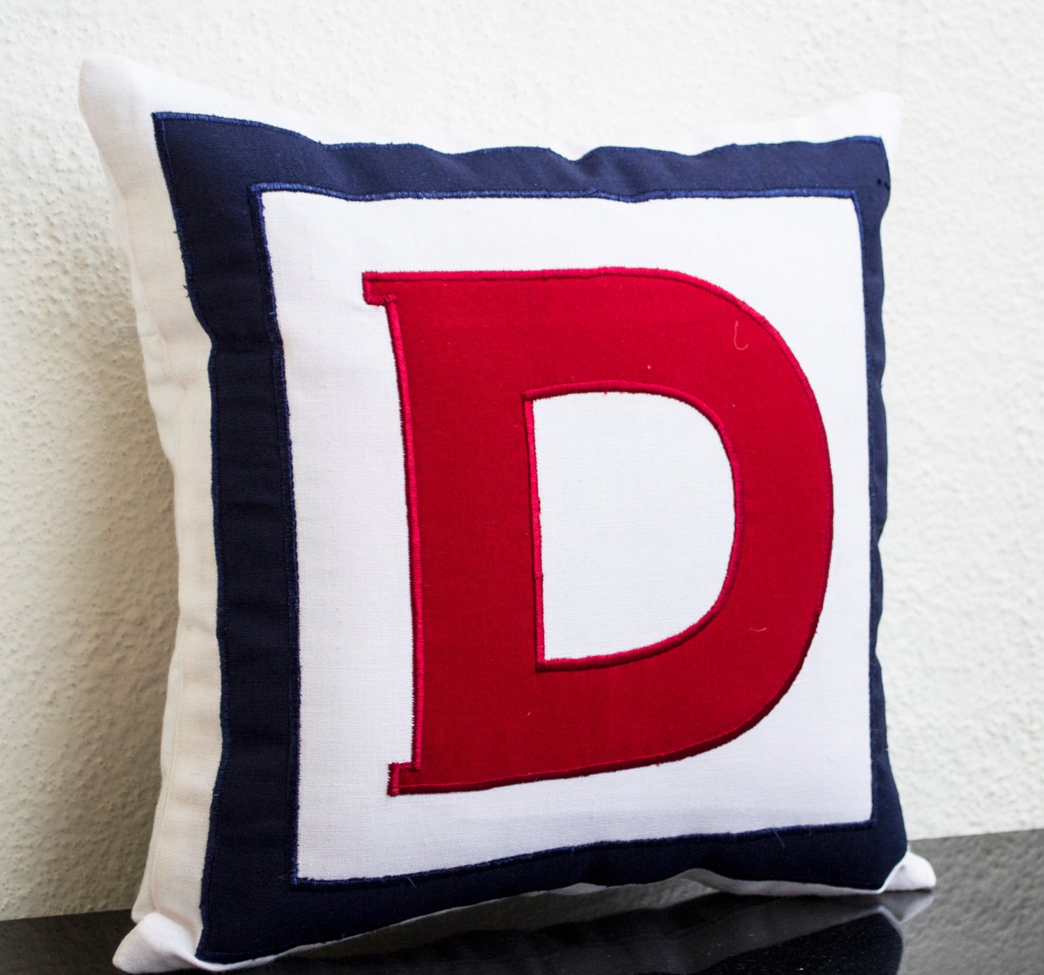 Monogrammed throw pillows in multiple colors