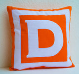 Handmade bold orange and white monogrammed alphabet pillow