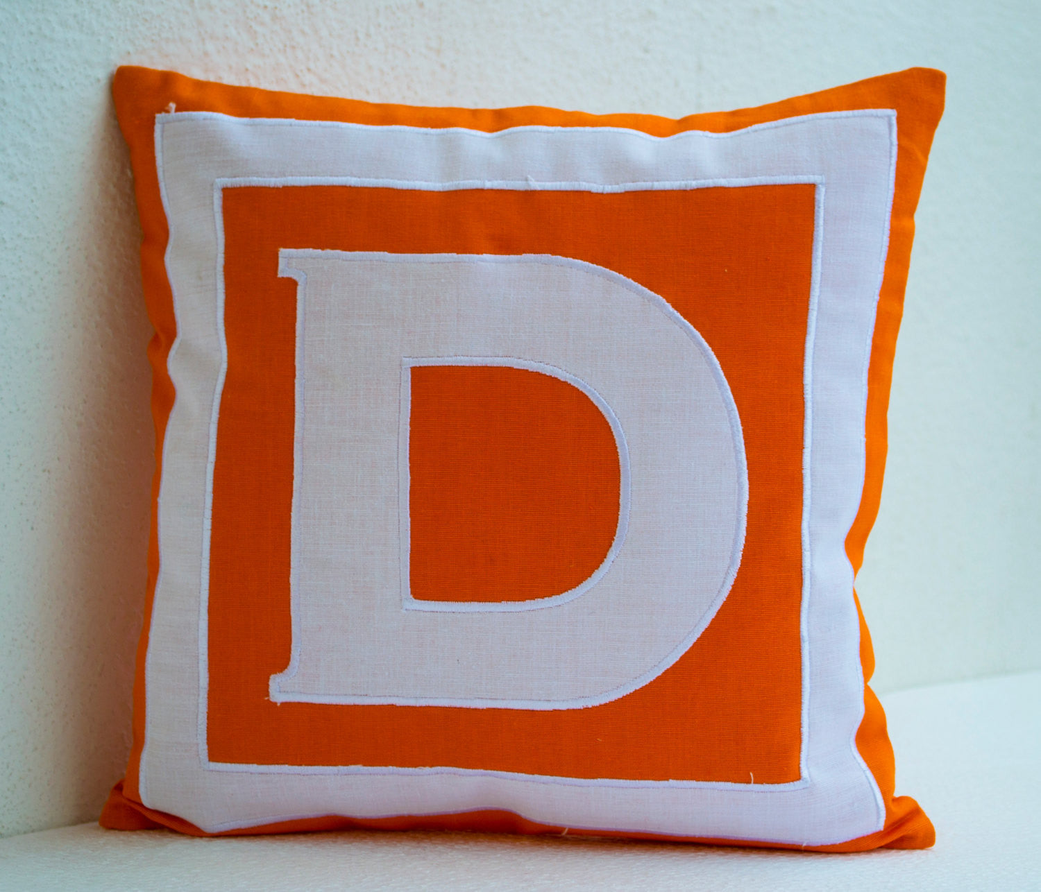Handmade bold orange and white monogrammed alphabet pillow