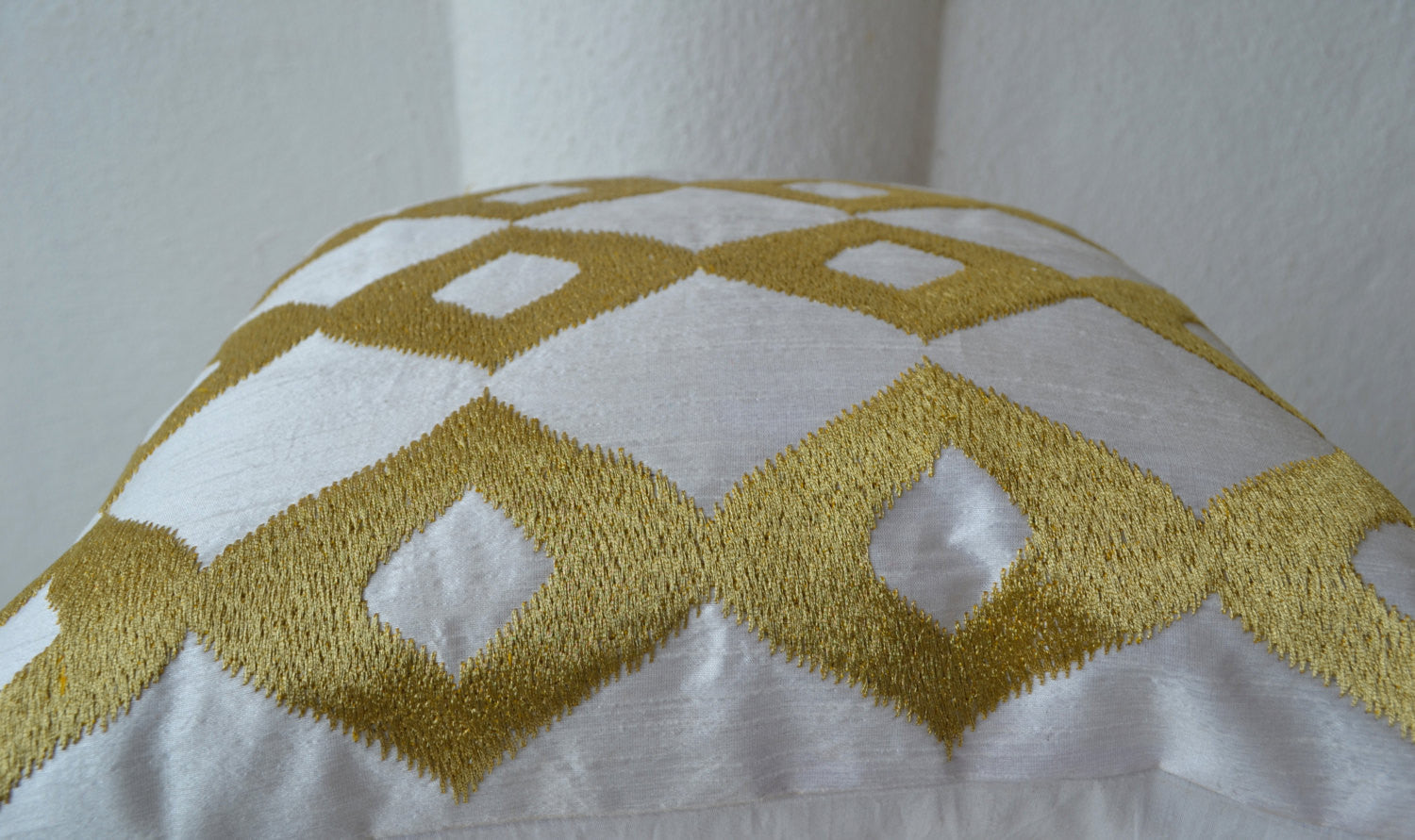 Handmade white gold silk pillows with ikat embroidery